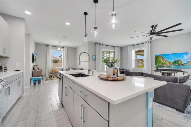 a kitchen with stainless steel appliances granite countertop a sink and a stove