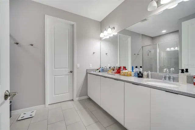 a bathroom with a double vanity sink and a mirror