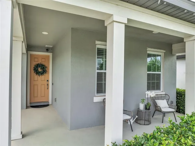 a view of a hallway with dining room and glass door