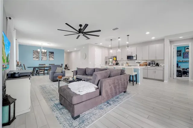 a living room with furniture and kitchen view