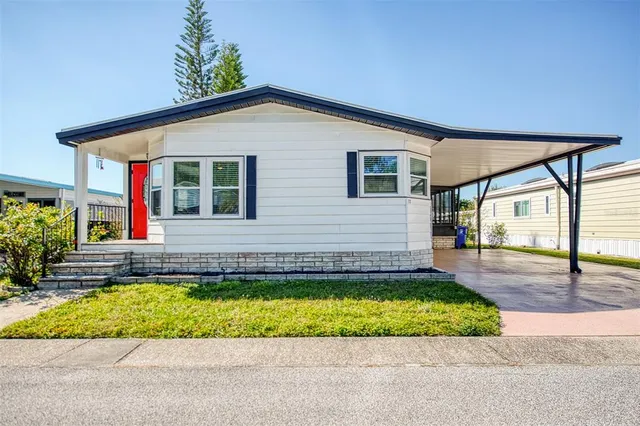 a view of a house with a swimming pool and a yard