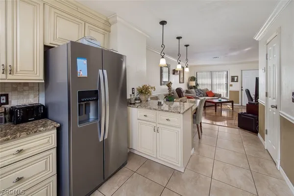 a kitchen with stainless steel appliances a refrigerator sink and cabinets