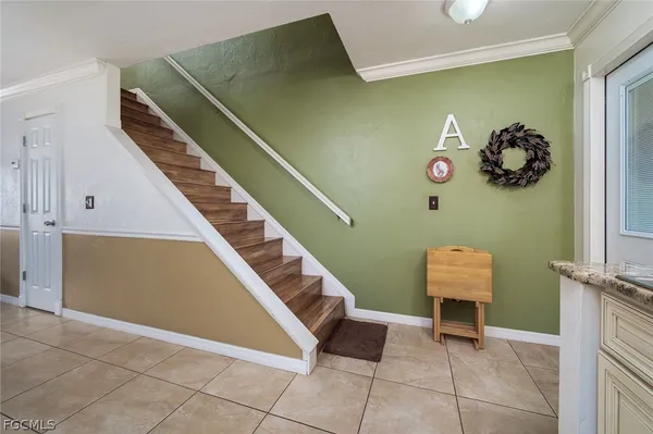 a view of an entryway with a flower pot and a bookshelf
