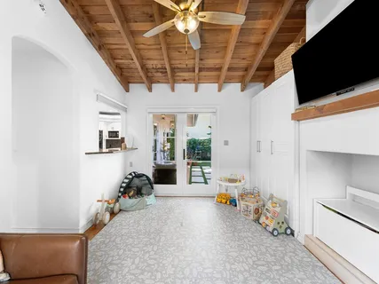 a hallway with furniture and a flat screen tv