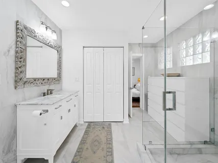 a bathroom with a double vanity sink mirror and shower