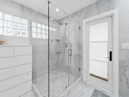 a bathroom with a shower and a sink