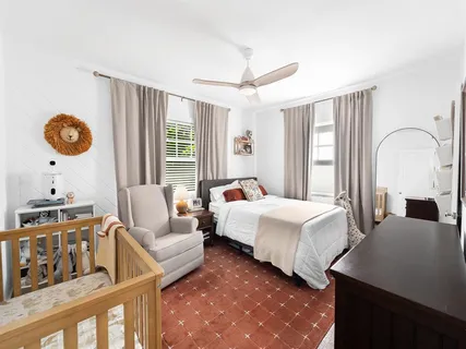 a bedroom with bed and window