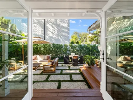 a view of living room with patio furniture and garden
