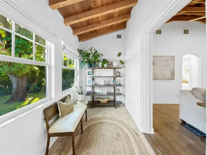 a view of a balcony with chairs and wooden floor