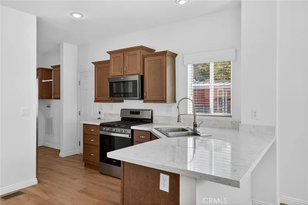 520 Pine Goleta Ca, Unit 55 Goleta, CA 93117 - Photo 12 of 25 a kitchen with kitchen island a sink appliances and cabinets