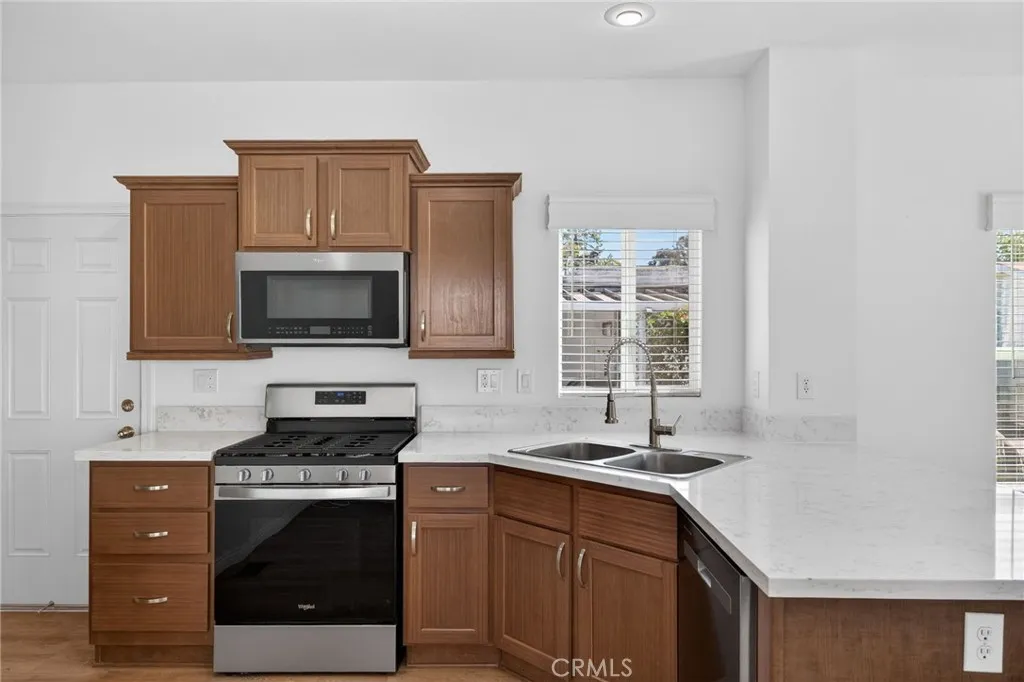 520 Pine Goleta Ca, Unit 55 Goleta, CA 93117 - Photo 13 of 25 a kitchen with stainless steel appliances a stove microwave and sink