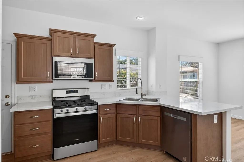 520 Pine Goleta Ca, Unit 55 Goleta, CA 93117 - Photo 14 of 25 a kitchen with stainless steel appliances a sink dishwasher stove and oven