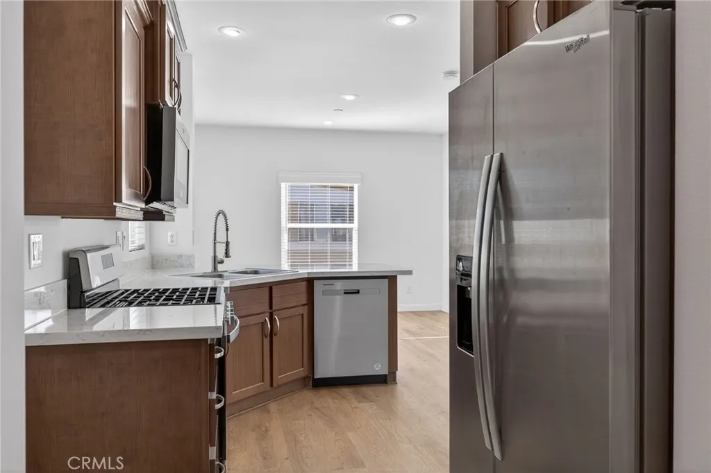 520 Pine Goleta Ca, Unit 55 Goleta, CA 93117 - Photo 18 of 25 a kitchen with stainless steel appliances granite countertop a refrigerator a sink a stove and island