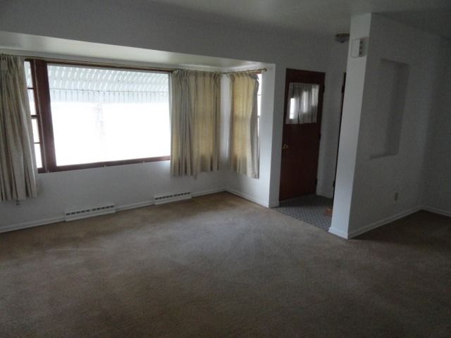 320 Ave G Rochelle, IL 61068 - Photo 3 of 6 an empty room with a window