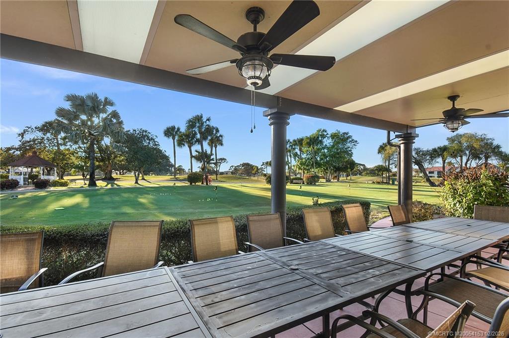 5413 Southeast Miles Grant Road, Unit G206 Stuart, FL 34997 - Photo 35 of 79 a view of a patio with table and chairs floor to ceiling window with garden