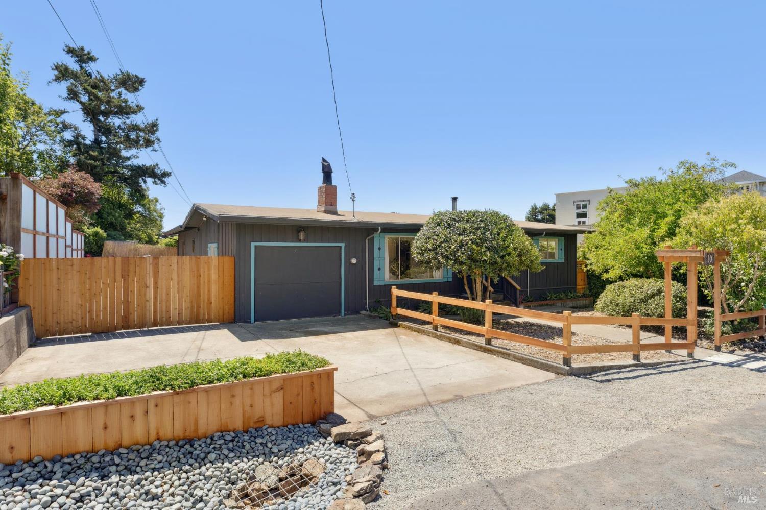 a view of a backyard with couches table and potted plants
