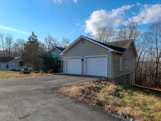 a view of a house with wooden fence