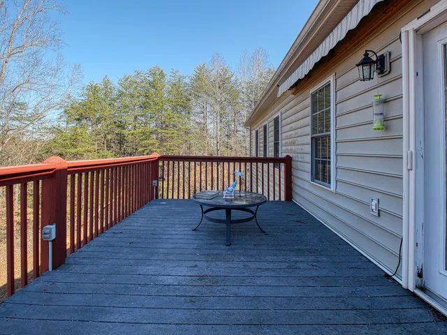 a view of a roof deck with wooden floor and a bench
