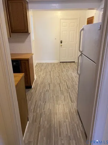 a view of a kitchen from a hallway