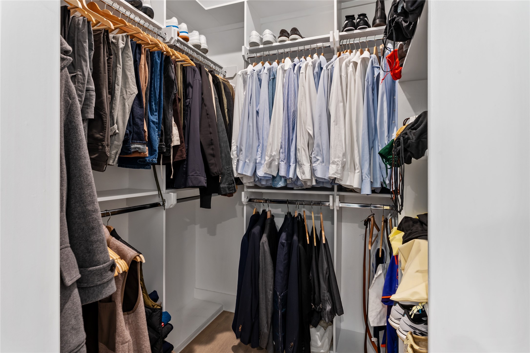 820 East 24th Street Houston, TX 77009 - Photo 24 of 34 An exceptionally designed walk-in closet featuring custom built-ins, double hanging rods, and ample shelving for optimal organization. Dedicated shoe storage and thoughtfully arranged compartments maximize both function and style. A dream space for keeping everything beautifully in place.