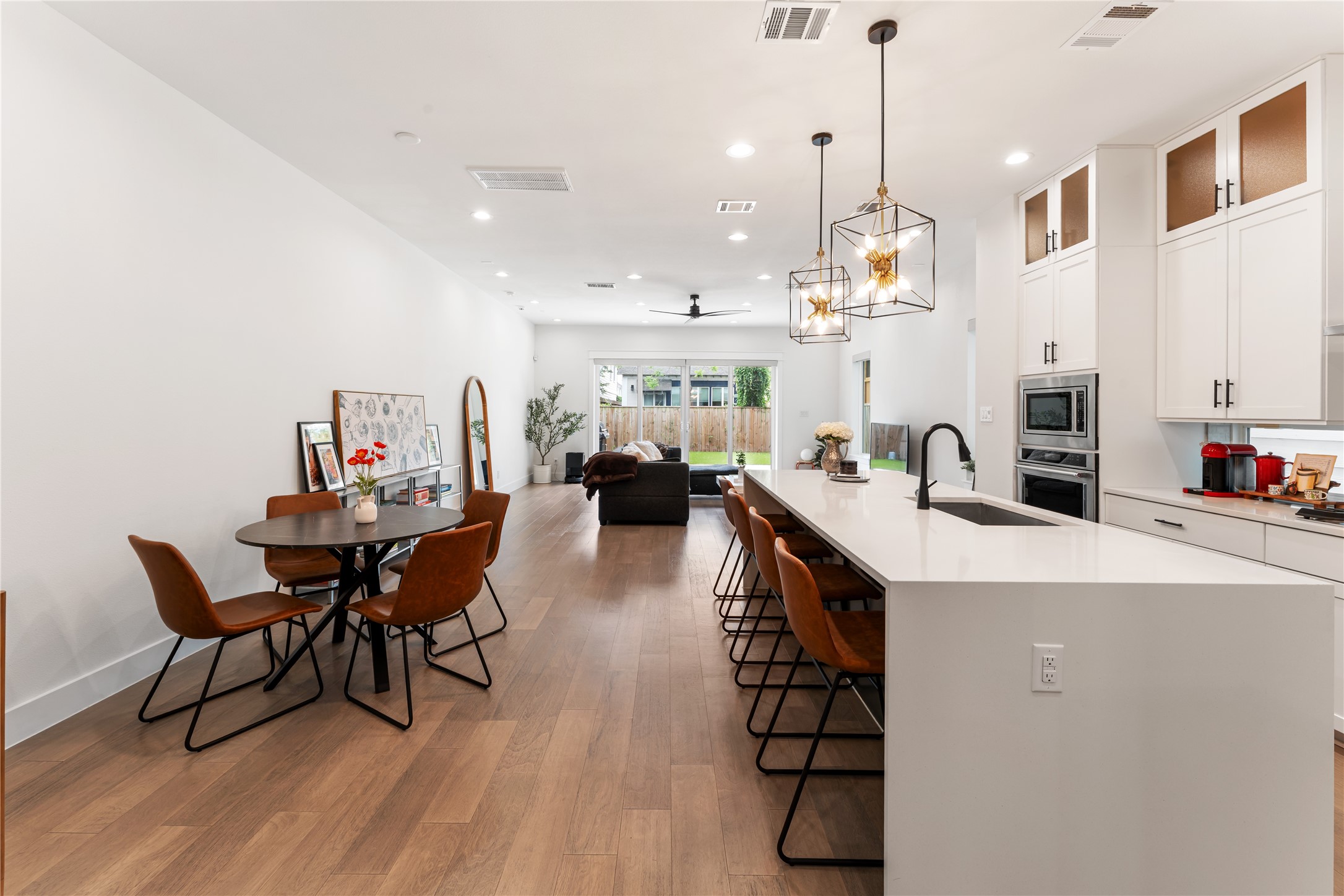 820 East 24th Street Houston, TX 77009 - Photo 5 of 34 The open-concept design seamlessly connects the kitchen, dining, and living areas for effortless everyday living. Natural light pours in, enhancing the spacious layout and modern finishes. This is the heart of the home—perfect for entertaining or relaxing in style.