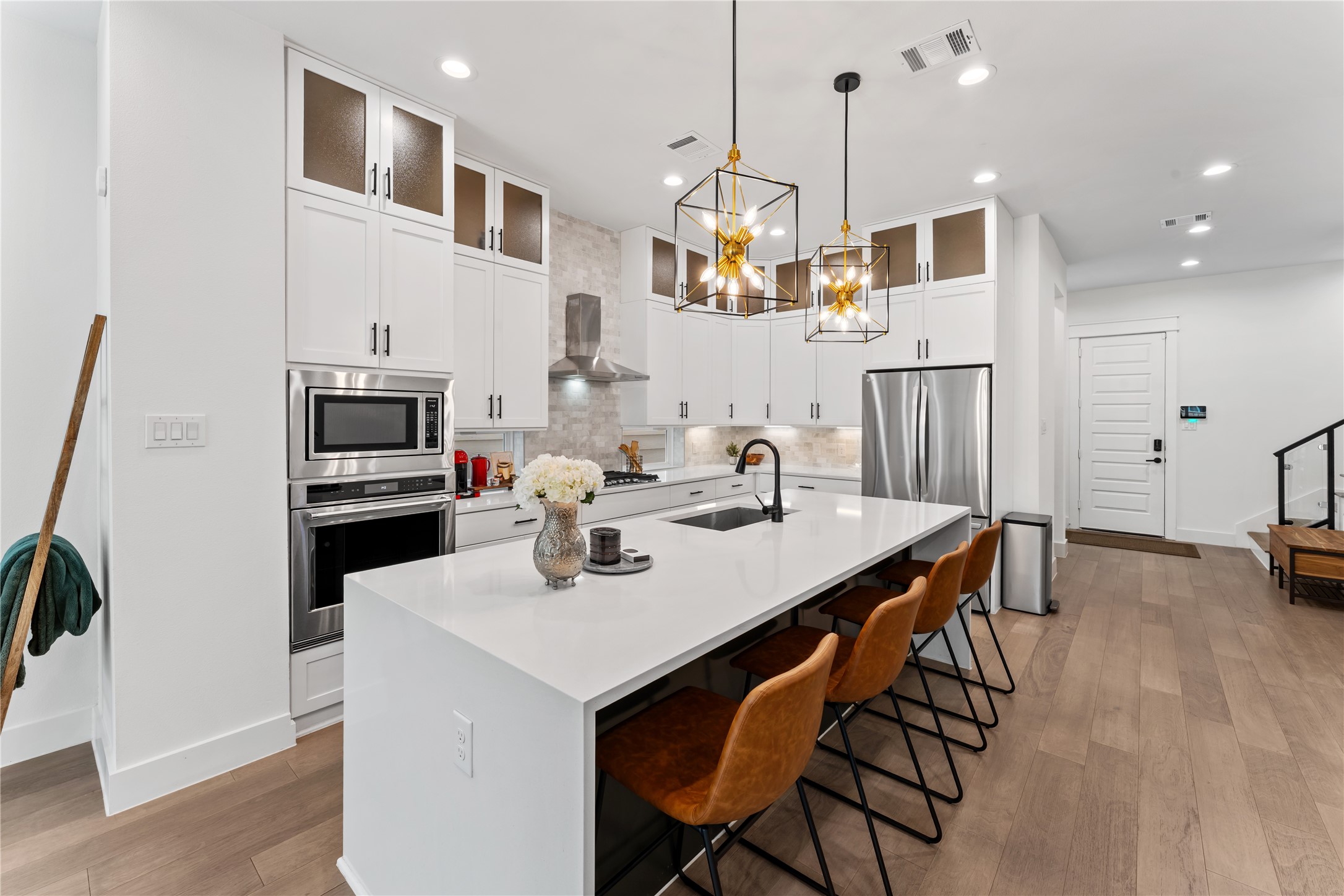 820 East 24th Street Houston, TX 77009 - Photo 8 of 34 From this angle, the kitchen’s abundant cabinetry and storage truly shine. The walk-in pantry and smart layout ensure everything has its place. A perfect blend of elegance and everyday functionality.