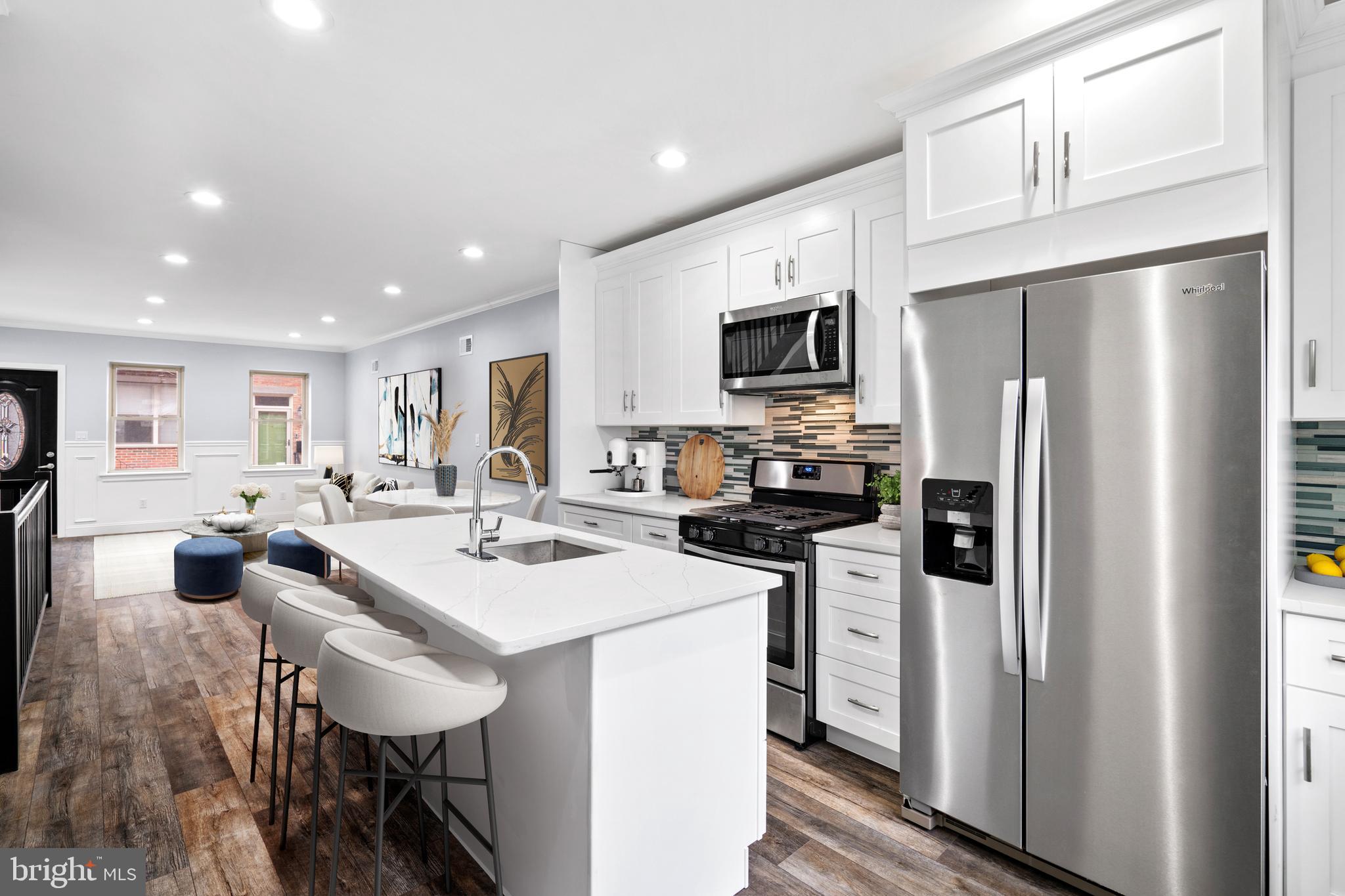 1605 Manton Street Philadelphia, PA 19146 - Photo 3 of 21 a kitchen with refrigerator and chairs