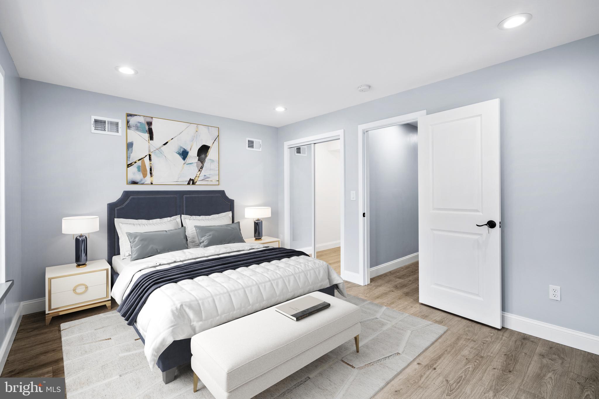 1605 Manton Street Philadelphia, PA 19146 - Photo 10 of 21 a spacious bedroom with a bed and a painting on the wall