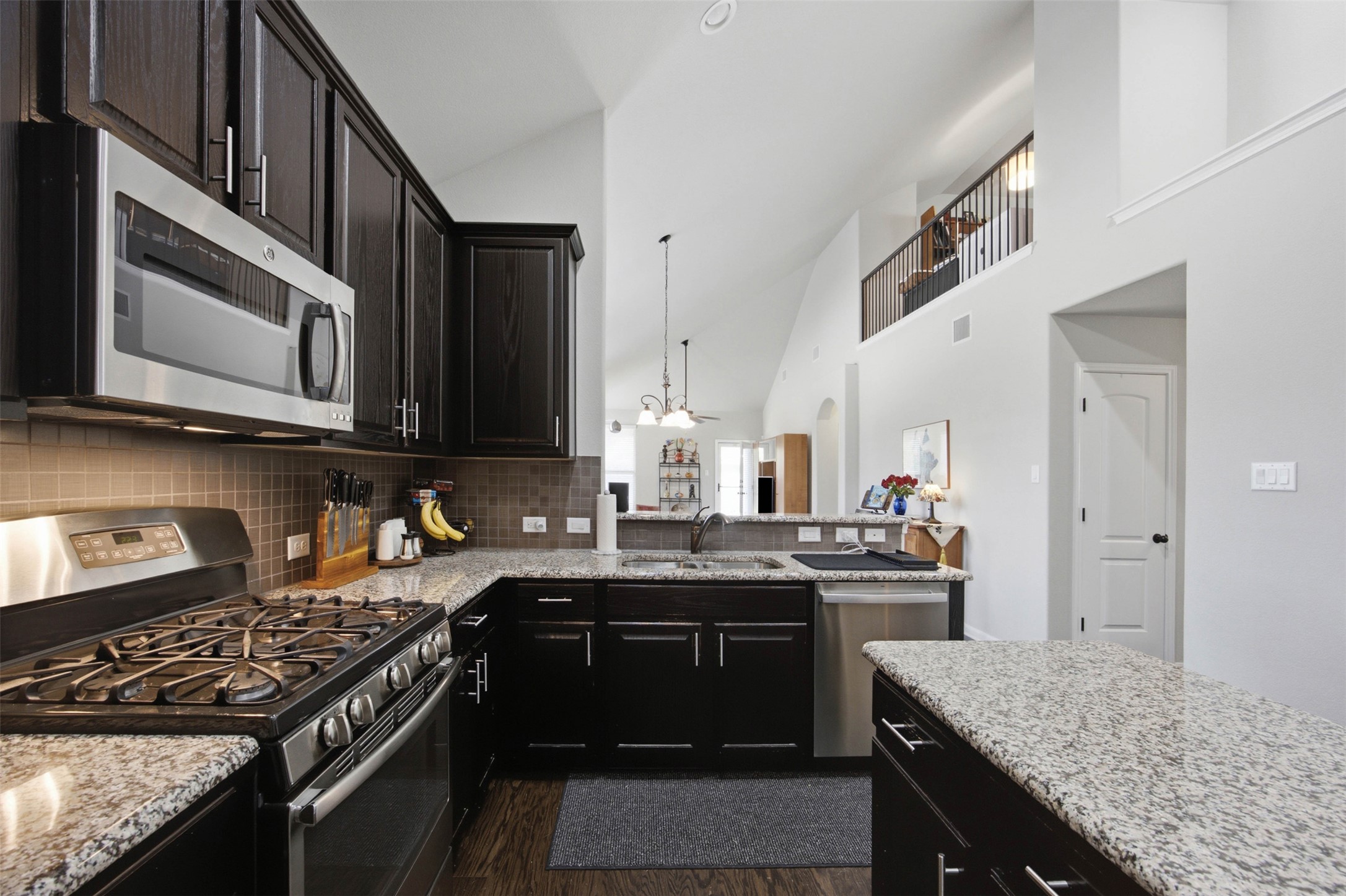 328 Rock Mill Loop Georgetown, TX 78626 - Photo 8 of 29 Thoughtful storage and generous workspace make this kitchen a true chef's delight. The layout connects seamlessly to the dining and living areas. It is ideal for hosting family and friends.