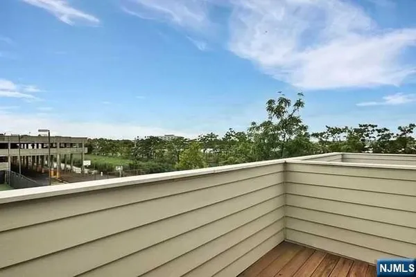 a view of a balcony with an outdoor seating