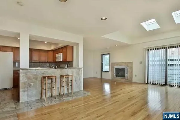a open kitchen with a sink and a fireplace