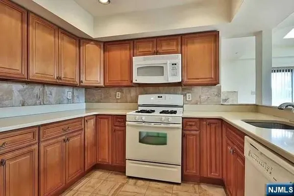 a kitchen with cabinets appliances and a sink