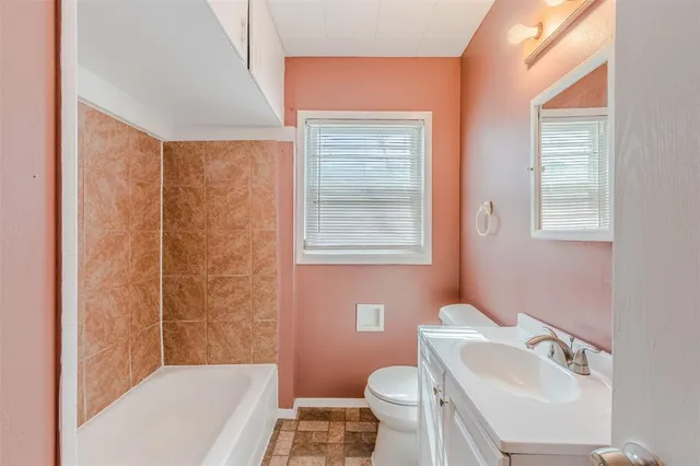 a bathroom with a sink toilet a mirror and shower