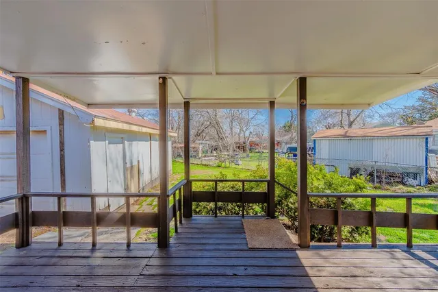 a view of a balcony with wooden floor