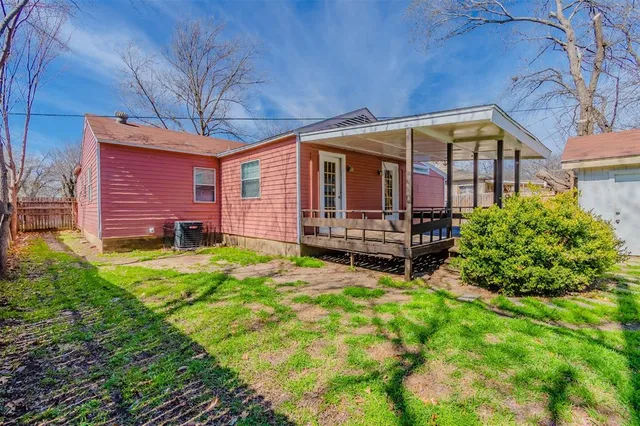 a backyard of a house with yard and outdoor seating