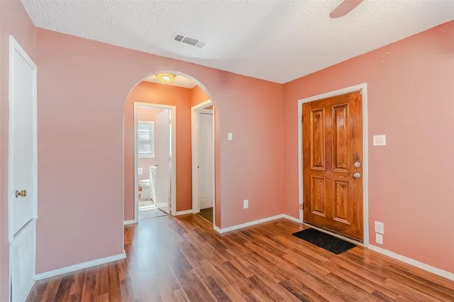 a view of a room with wooden floor and window