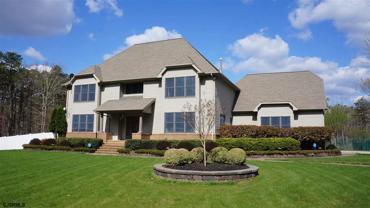 323 Cologne Port Road Port Republic, NJ 08241 - Photo 1 of 1 a front view of a house with a yard and garage