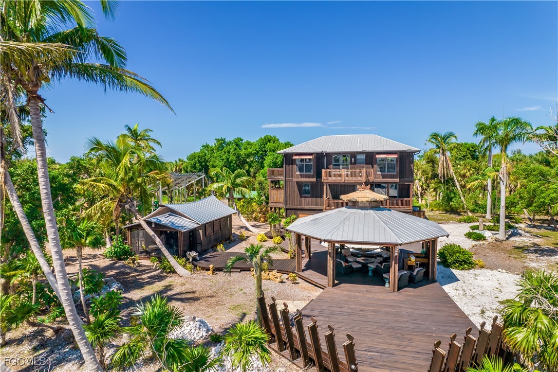 1000 Cayo Costa Boca Grande, FL 33921 - Photo 11 of 47 a view of a table and chairs in patio