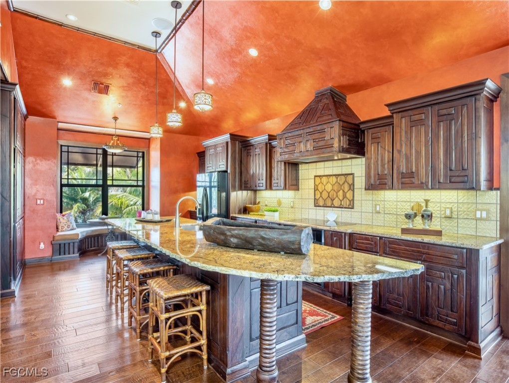 1000 Cayo Costa Boca Grande, FL 33921 - Photo 25 of 47 a kitchen with a table chairs stove and wooden floor