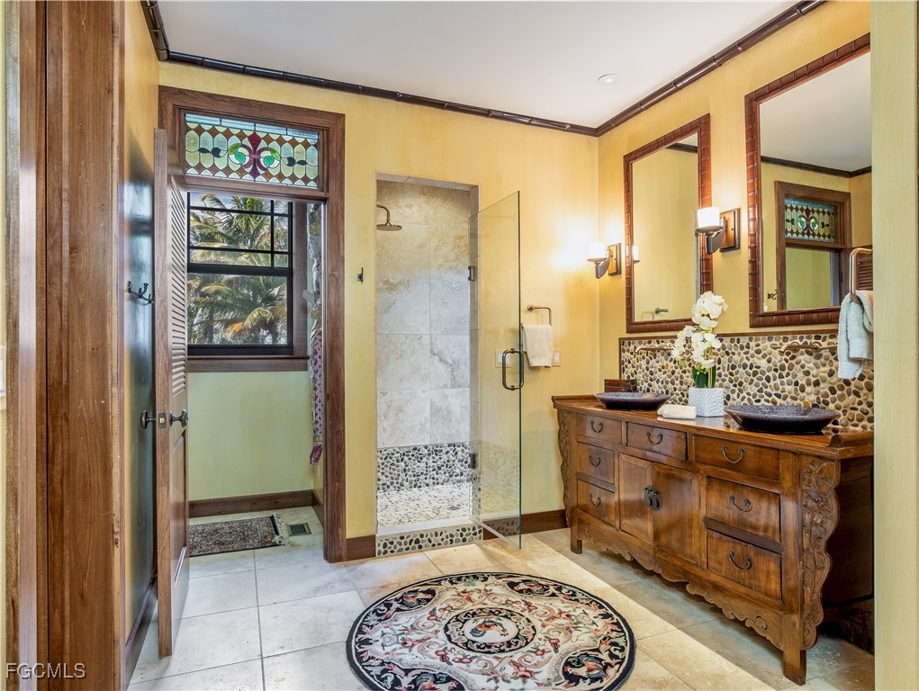 1000 Cayo Costa Boca Grande, FL 33921 - Photo 30 of 47 a spacious bathroom with a granite countertop sink a mirror and a shower