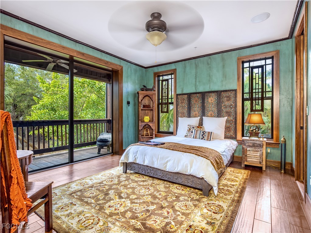 1000 Cayo Costa Boca Grande, FL 33921 - Photo 33 of 47 a bedroom with a large bed and a chandelier