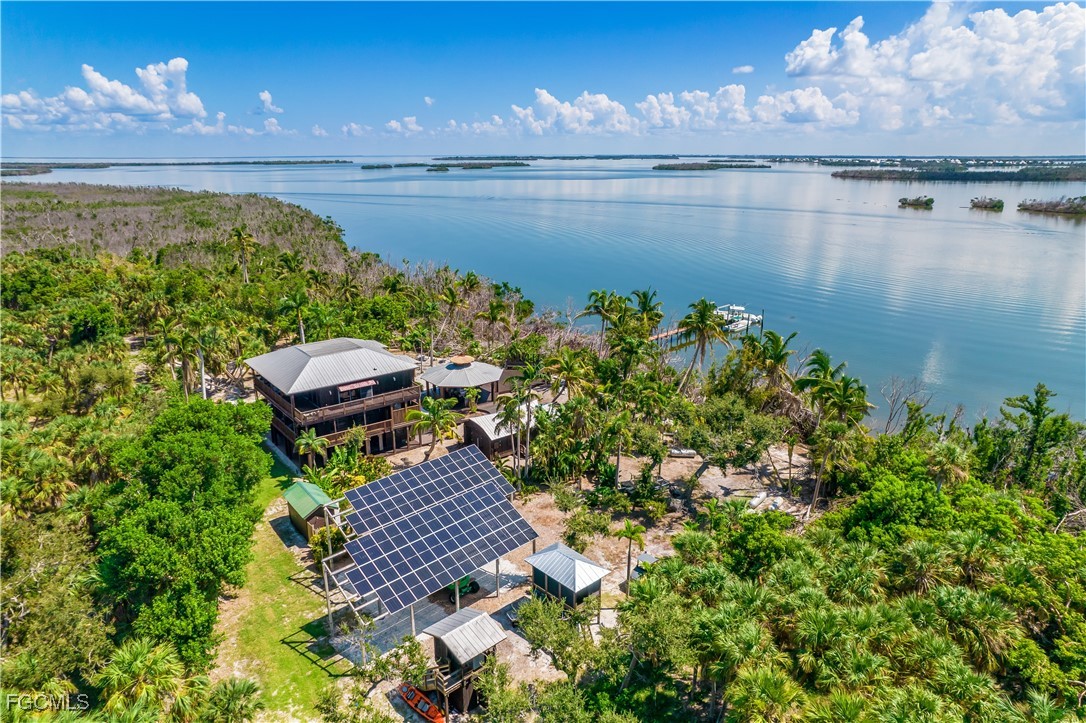 1000 Cayo Costa Boca Grande, FL 33921 - Photo 4 of 47 a view of a balcony with dining table and chairs with wooden floor