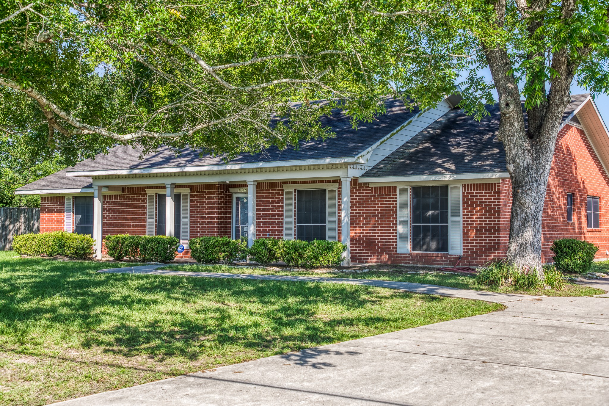 1687 Eagle Lake Road Sealy, TX 77474 - Photo 2 of 27 a front view of a house with garden