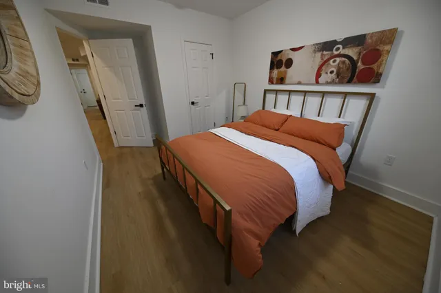 a bed sitting in a bedroom next to a window