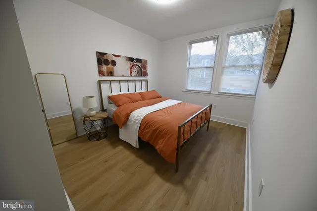 a bedroom with a bed and a large window