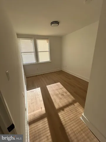 a view of an empty room and wooden floor