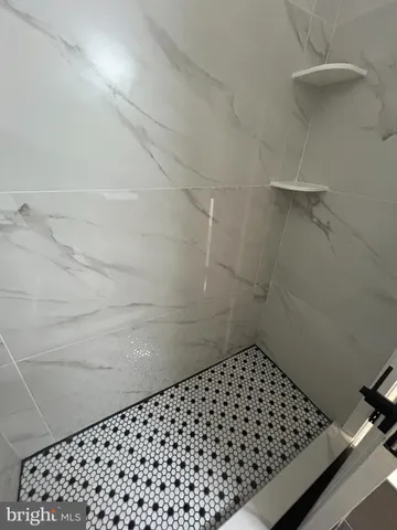 a bathroom with a black white checkered floor