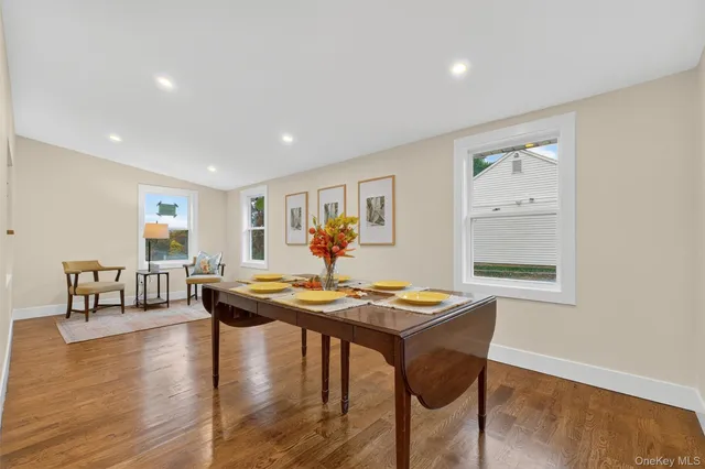 a living room with dining table and wooden floor