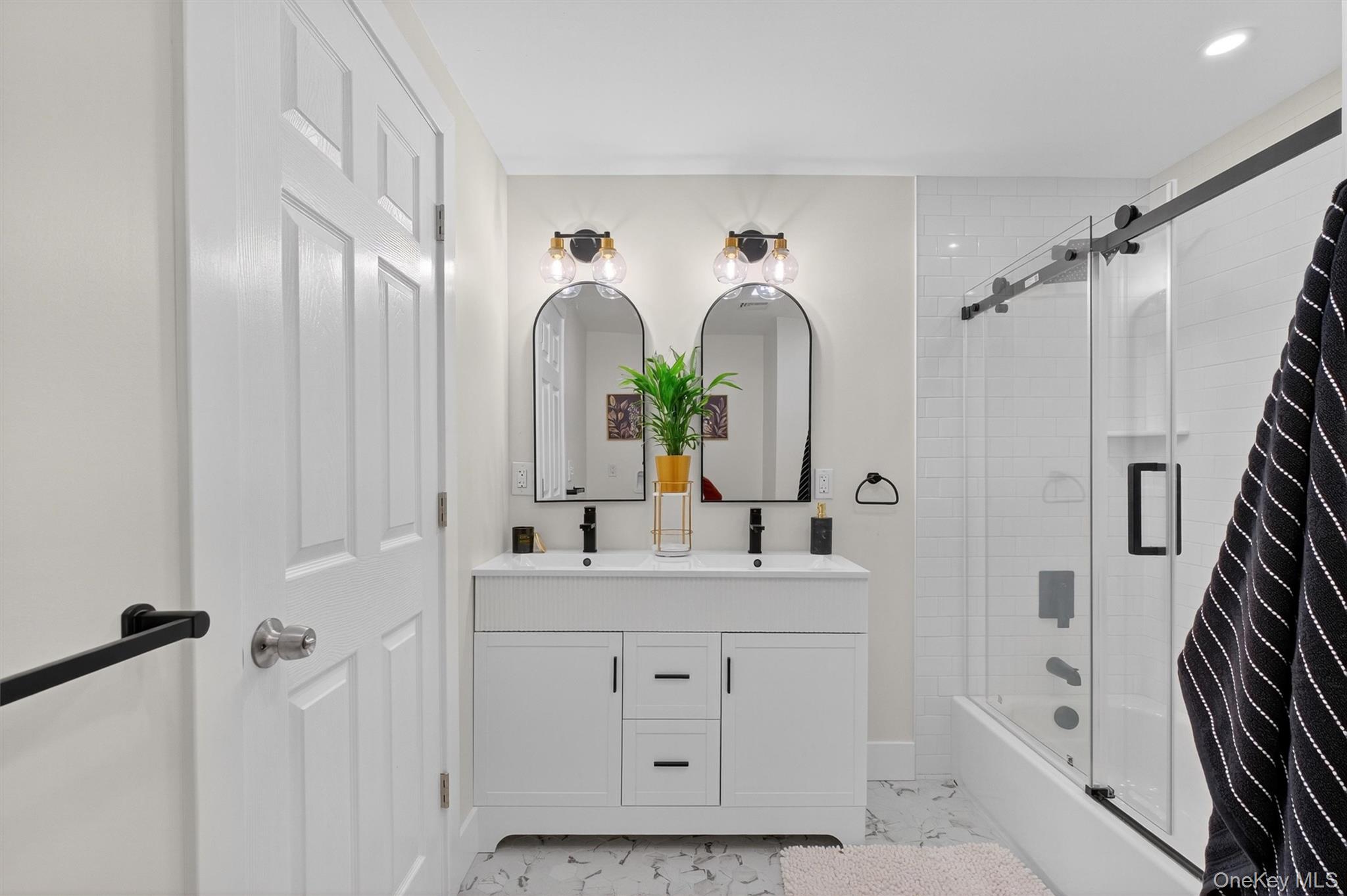 86 Vassar Road Poughkeepsie, NY 12603 - Photo 17 of 32 a bathroom with double vanity sink a two mirror a bathtub and shower