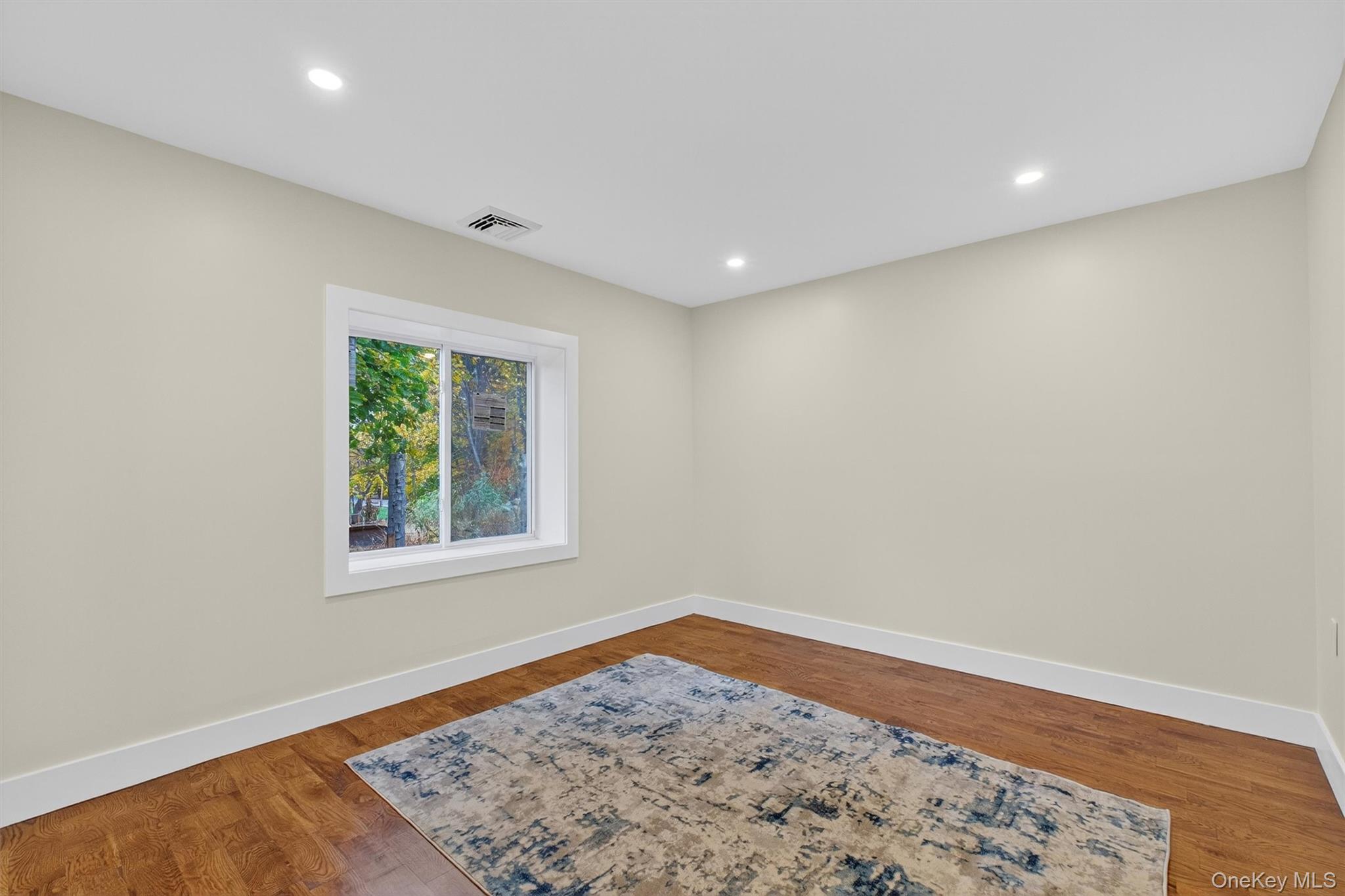 86 Vassar Road Poughkeepsie, NY 12603 - Photo 21 of 32 an empty room with wooden floor and a window